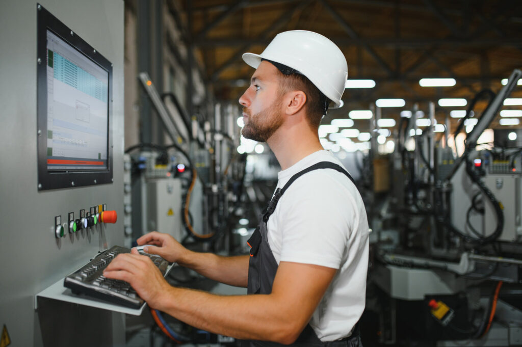 Technician operating machine in a factory.