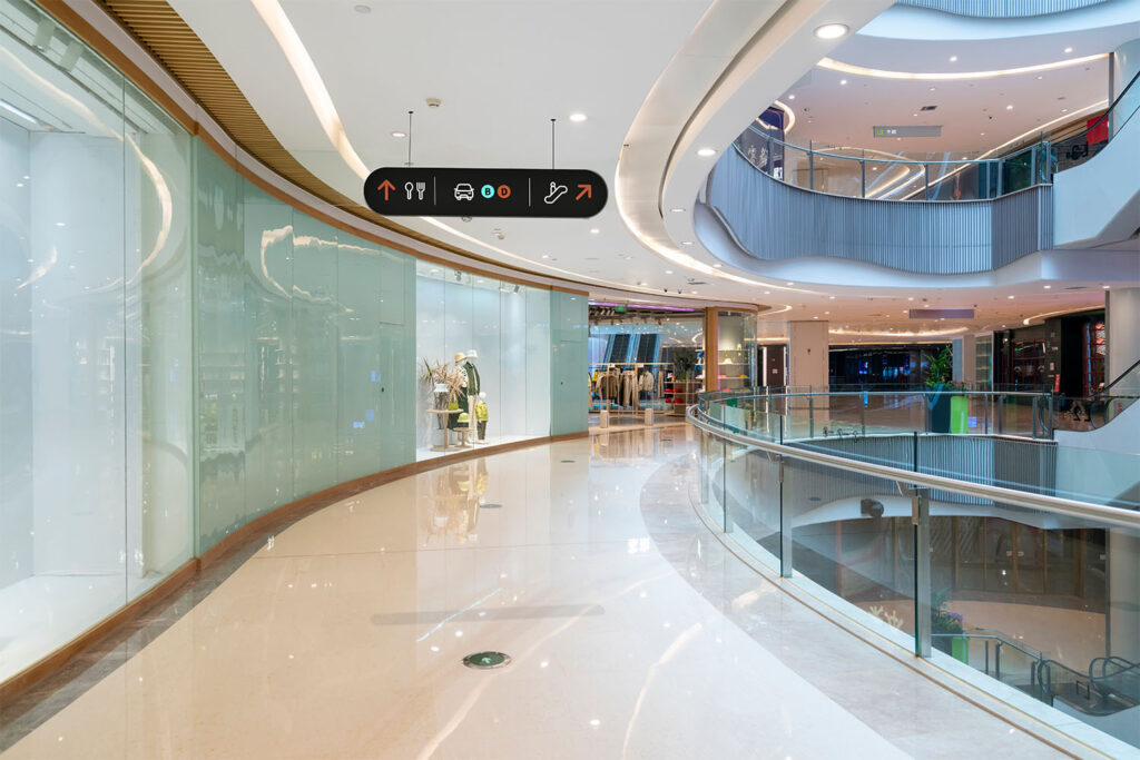 Hanging directional sign in shopping mall corridor