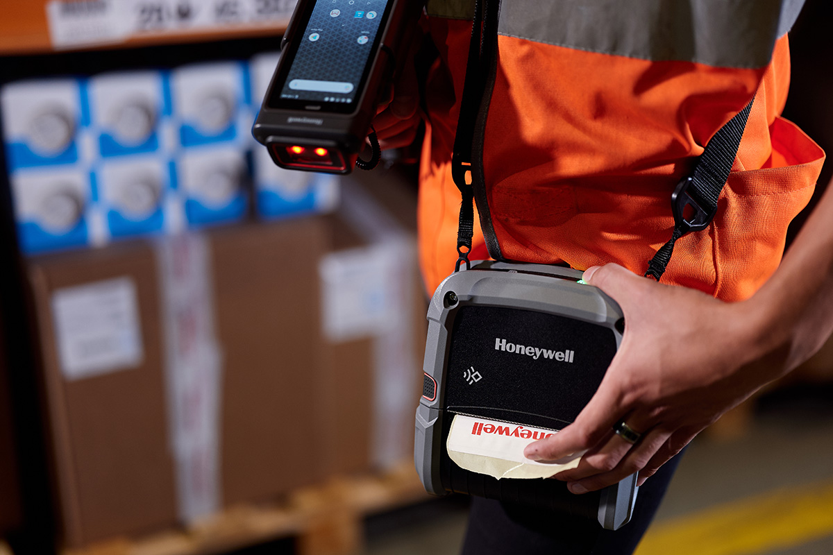Zdjęcie pracownika magazynu drukującego etykiety z pomocą drukarki etykiet Honeywell CN80