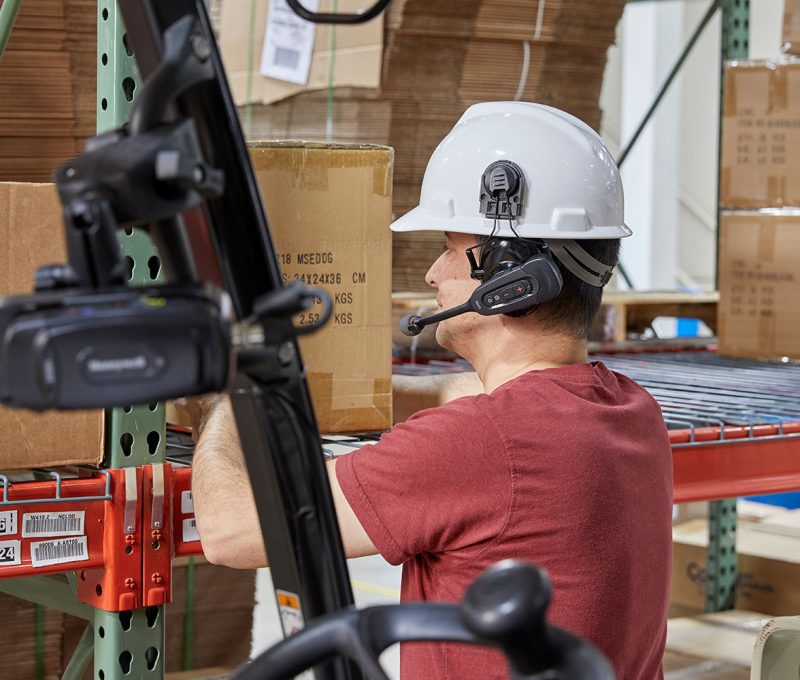 Warehouse worker picks goods using Voice Picking technology