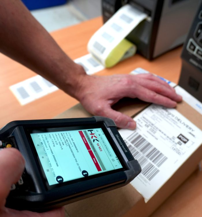 A warehouse worker scans a shipping label