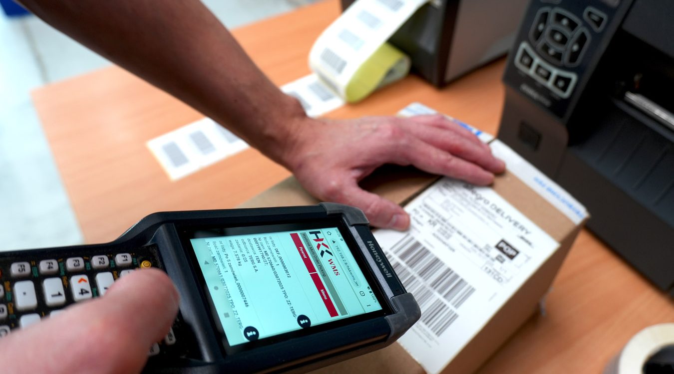 A warehouse worker scans a shipping label