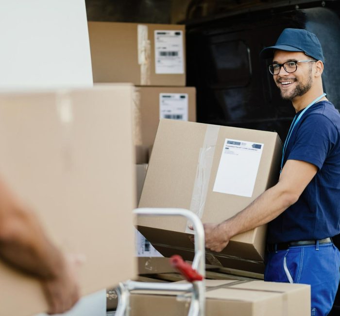 Couriers packing parcels into a bus